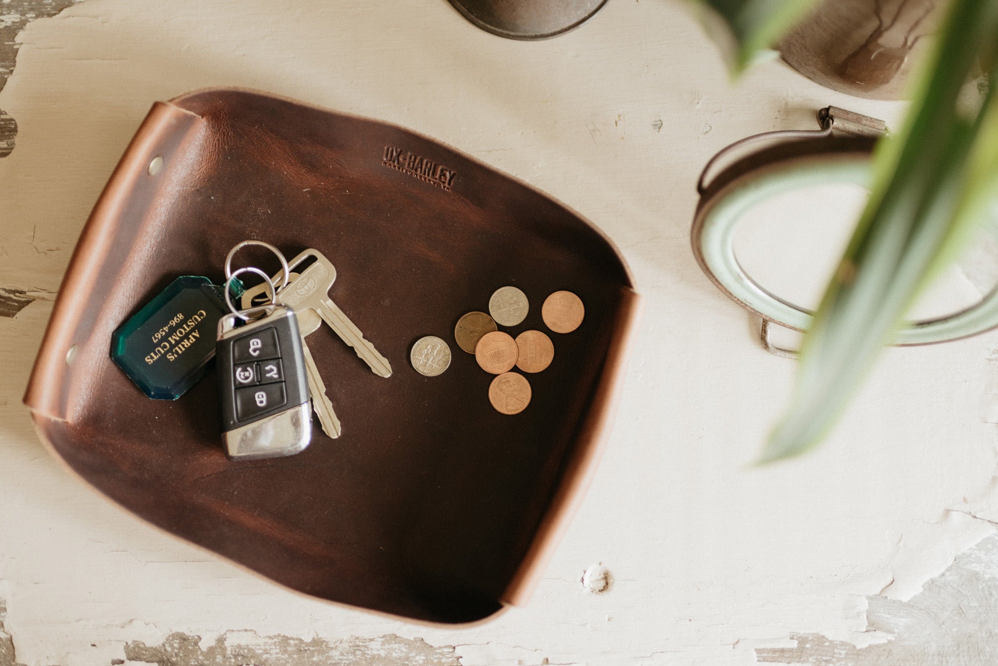 Full-grain leather butler tray holding keys, wallet and everyday carry