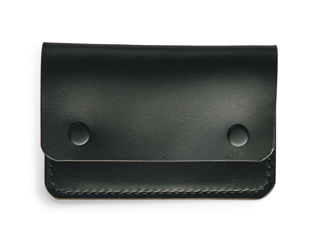 Slim card wallet in black harness leather with solid brass snap