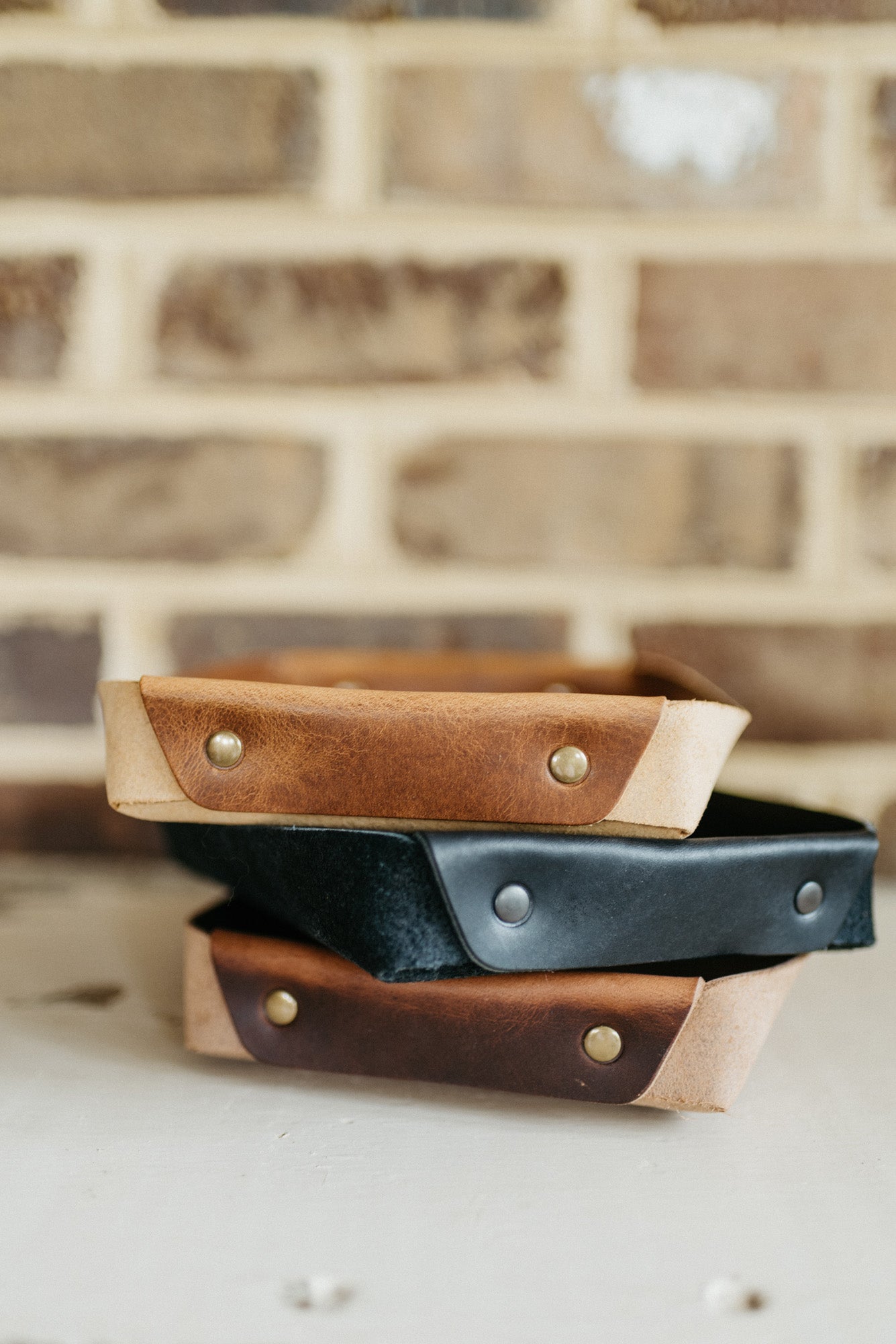 Full-grain leather butler tray holding keys, wallet and everyday carry