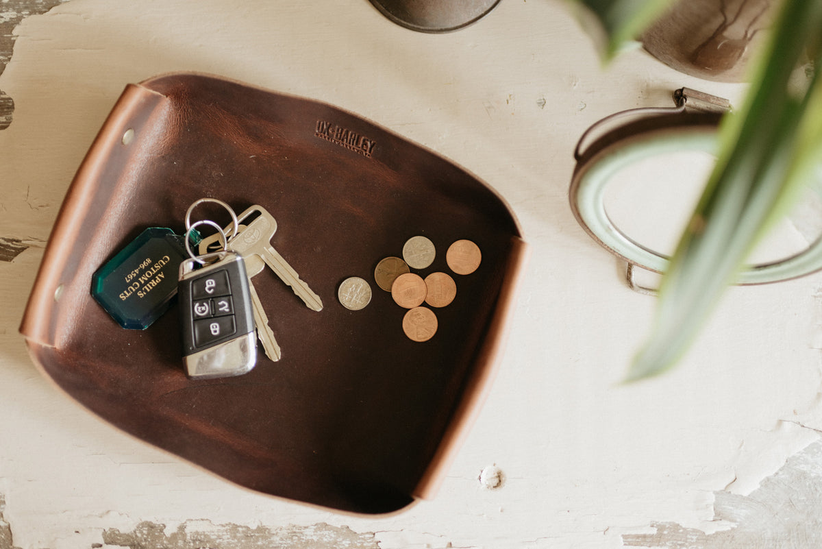 Full-grain leather butler tray holding keys, wallet and everyday carry