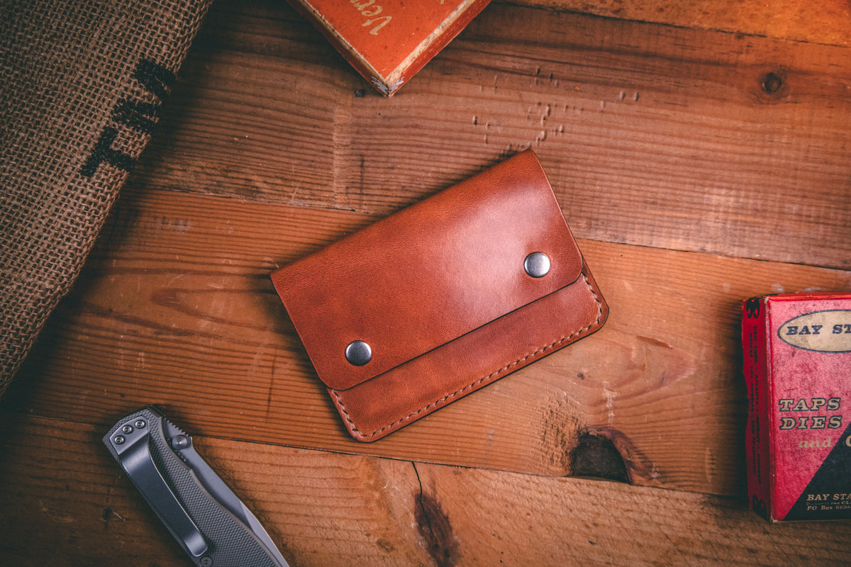 Slim card wallet in buck brown harness leather with solid brass snap