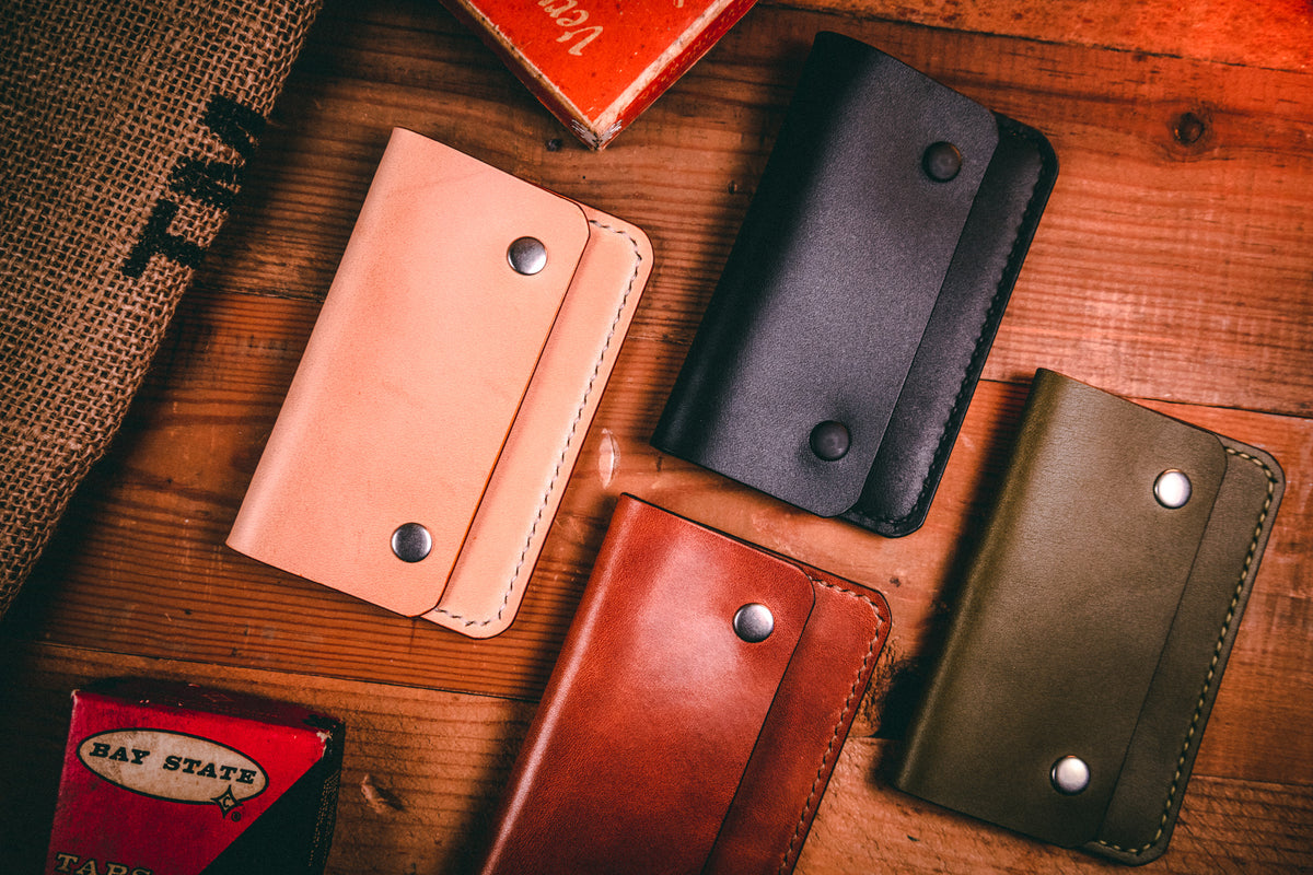 Slim card wallet in buck brown harness leather with solid brass snap