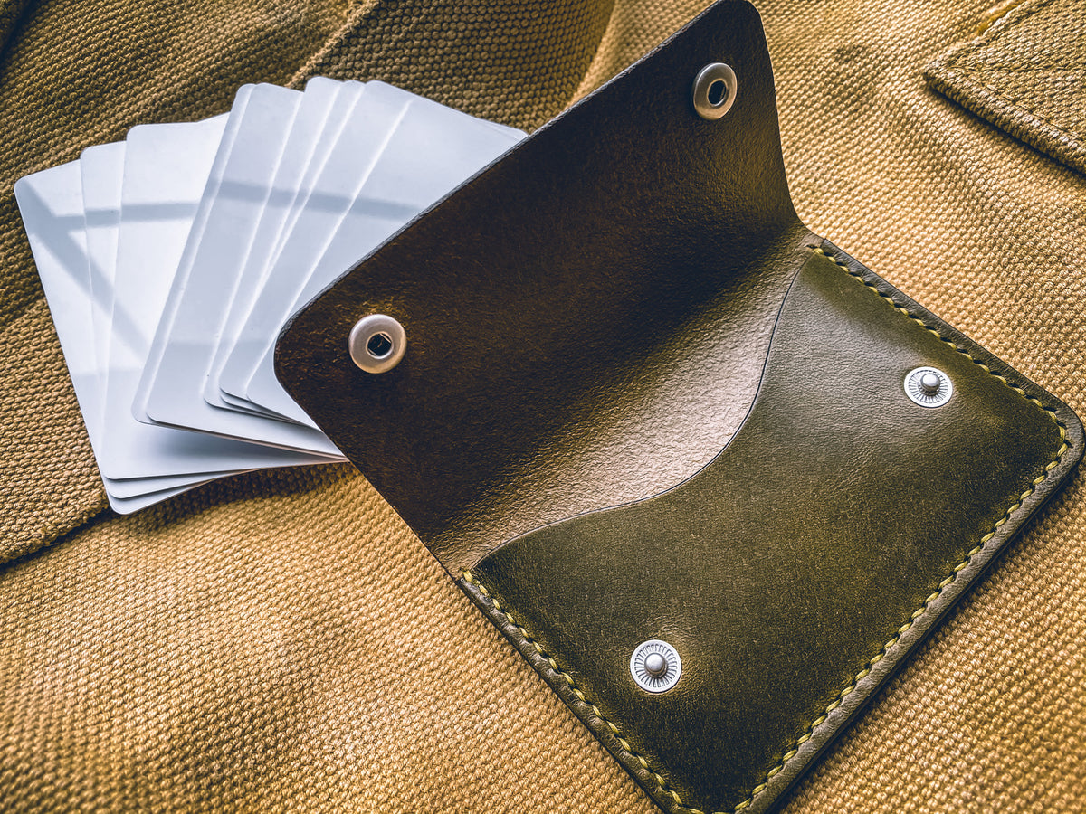 Slim card wallet in olive harness leather with solid brass snap