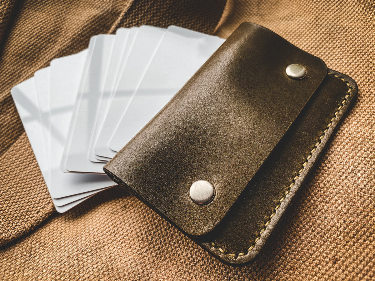 Slim card wallet in olive harness leather with solid brass snap