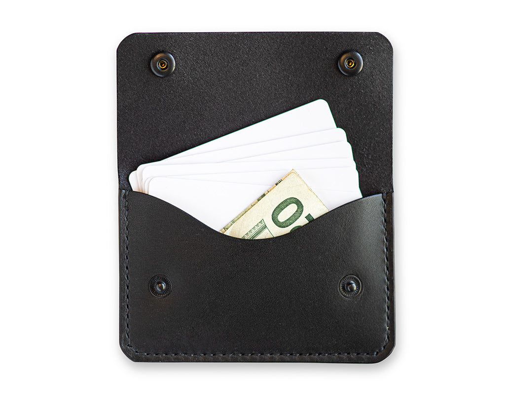 Slim card wallet in black harness leather with solid brass snap