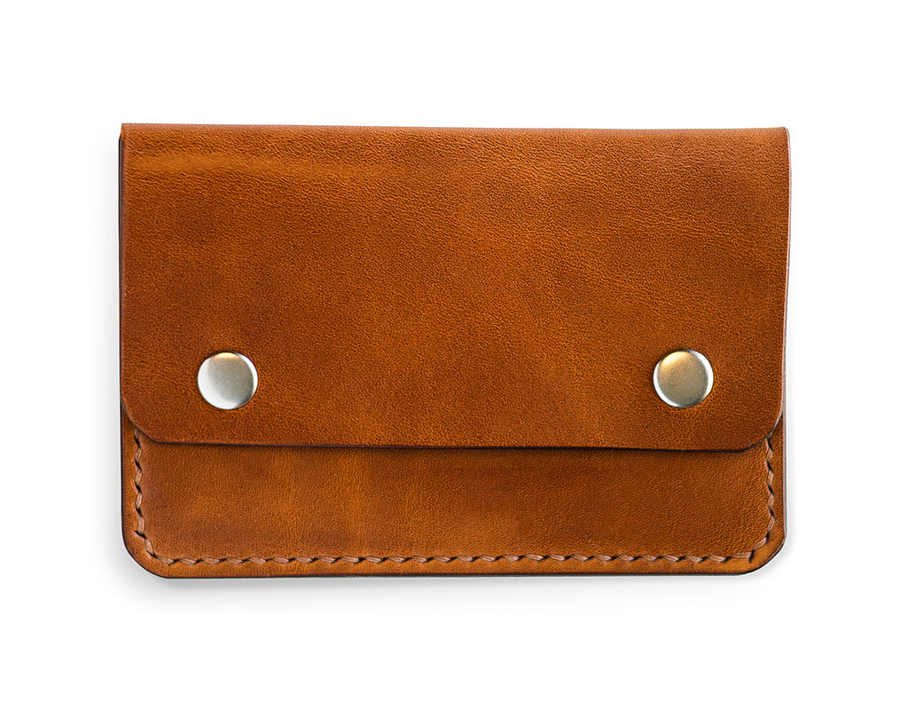 Slim card wallet in buck brown harness leather with solid brass snap