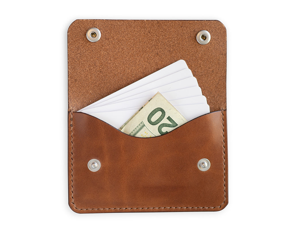 Slim card wallet in buck brown harness leather with solid brass snap