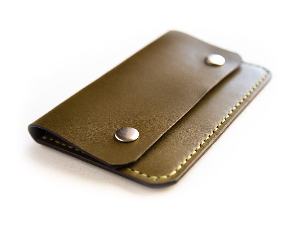 Slim card wallet in olive harness leather with solid brass snap